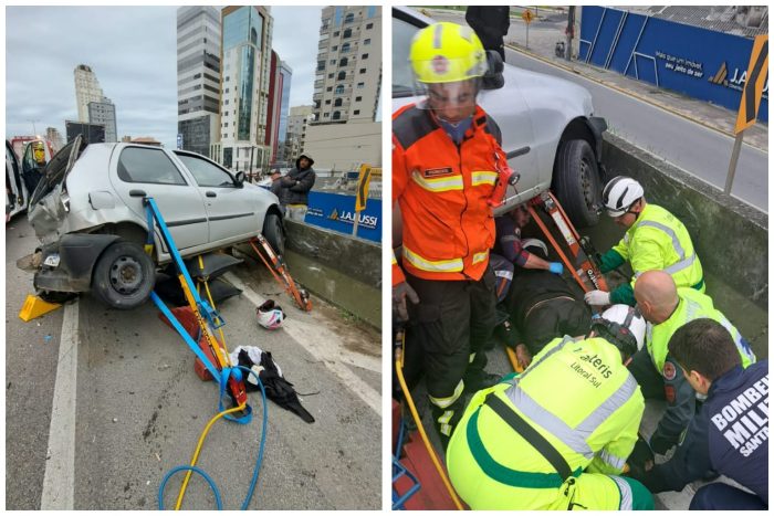Caminhão bate em carro parado e prensa motociclista contra mureta na BR-101